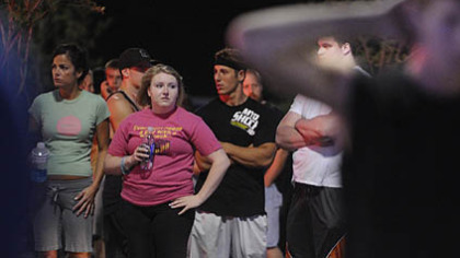 LA Fitness members wait outside the center after the shooting.