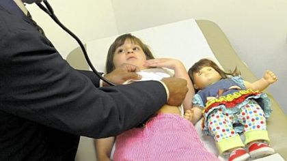 Dr. Abhay Vats, a nephrologist at Children's Hospital, checks Kate Verone, 5, of Beaver at the hospital in Lawrenceville on Thursday. It is her first trip to the new location.