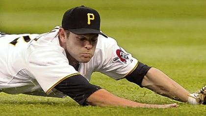 Pirate's second baseman Freddy Sanchez runs under a ball hit in a steady drizzle during the third inning as right fielder Brandon Moss looks on.
