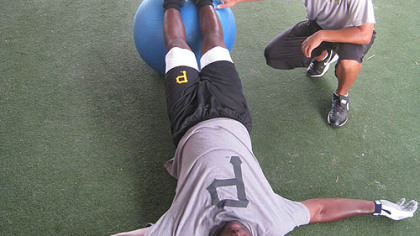 Pirates outfielder Lastings Milledge works out with conditioning coordinator Bill Burgos yesterday at Pirate City in Bradenton, Fla.