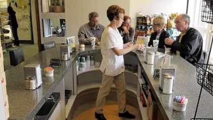 Anita Schock, of Finleyville, waits on her customers in one of three U-shaped counters at the snack shop in St. Clair Hospital. She has worked there for more than 17 years.