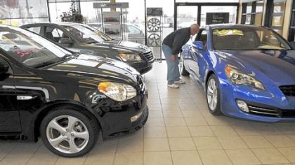 Mike Sieber, of North Attleboro, Mass., looks at new cars in the showroom of Pride Hyundai in Lynn, Mass.