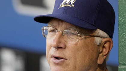 Brewers manager Ken Macha stands in the dugout.