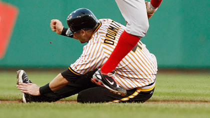 Ryan Doumit, bottom, slides under Reds' second baseman Brandon Phillips with a stolen base in the first inning Saturday night.