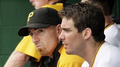 Former Pirates first baseman Adam LaRoche, left, sits in the dugout with his brother, third baseman Andy LaRoche.