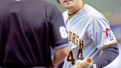 Brandon Moss argues a called third strike -- one of 11 strikeout victims for Milwaukee's Yovani Gallardo.