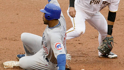 Pirates shortstop Ronnie Cedeno, right, can't handle the toss from second baseman Delwyn Young, not shown, allowing Chicago Cubs first baseman Derrek Lee to safely advance to second on a RBI fielder's choice by Cubs outfielder Milton Bradley in the fifth inning.