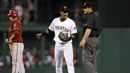 Pirates shortstop Ronny Cedeno argues with second base umpire Brian Knight after a close play on Diamondbacks infielder Mark Reynolds at second base in the sixth innning Tuesday night.