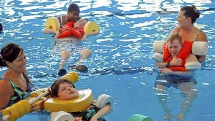 Children at Allegheny Valley School in Robinson take part in Aquatic Therapy class. From left are Elizabeth Mink with client Carol Valecko; Tenieda Greene with client Danny Barcelona; and Chris Hurt with client Sean Malley. The late Myron Cope gave trademark rights for his Terrible Towel to the school. Royalties from sales are used to benefit the school.