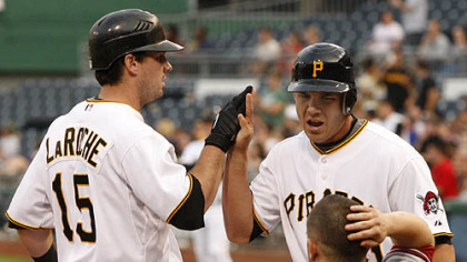 Pirates third baseman Andy LaRoche is greeted at home by teammate Steve Pearce after hitting a two-run homer in the second inning as Diamondbacks catcher Miguel Montero rubs his head.