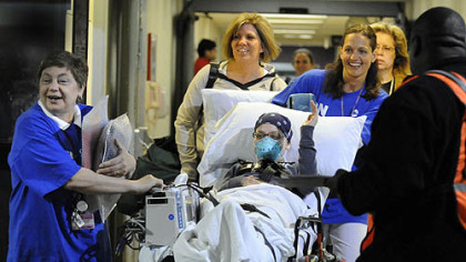 Cancer patient Rylee Brunette, 10, of Chippewa, waves to bystanders yesterday while being transported from Oakland to the new Children's Hospital location in Lawrenceville. She is the first patient being transferd around 7 a.m. The hospital transported 178 patients to the new Lawrenceville location.