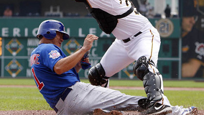 Pirates catcher Jason Jaramillo can''t handle the throw from center fielder Andrew McCutchen as Cubs outfielder Kosuke Fukudome scores from third on a sacrifice fly by Cubs third baseman Jeff Baker during the first inning.