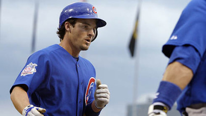 Cubs outfielder Ryan Theriot, left, returns to the dugout after hitting a home run in the third inning off Pirates pitcher Zach Duke.