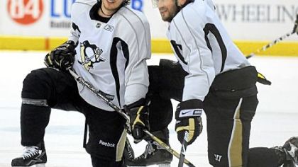 Sidney Crosby and Sergei Gonchar take a break during practice yesterday at Mellon Arena. The Penguins and Red Wings meet tonight in Game 6.