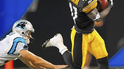 Steelers punt returner Stefan Logan hurdles past Panthers punter Jason Baker on his way to a touchdown in the first quarter at Bank of America Stadium Charlotte last night.
