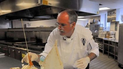 David Watson, of Brookline, a pastry chef and instructor at the Pennsylvania Culinary Institute, tries out his finishing touches on a sugar sculpture for a fundraising event.
