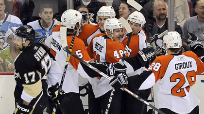 Flyers teammates congratulate Darroll Powe on his third-period goal.