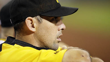 Pirates shortstop Jack Wilson, who had the night off, watches from the dugout.