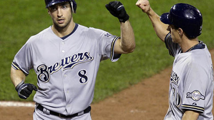 Brewers outfielder Ryan Braun (8) is greeted by teammate Craig Counsell after hitting a two-run home run in the ninth inning off Pirates pitcher Jesse Chavez.
