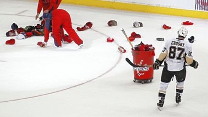 Sidney Crosby looks on as workers collect hats thrown onto the ice after the Capitals' Alex Ovechkin's third goal of the night in the third period of Game 2 of the NHL second-round playoff series in Washington.