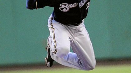 Delwyn Young breaks up a double play against Brewers shortstop Alcides Escobar.