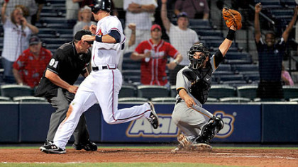 Braves' Jeff Francoeur scores past Pirates catcher Jason Jaramillo on a single off the bat of Braves' David Ross in the 15th inning early Tuesday morning in Atlanta.