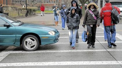 University of Pittsburgh students weave around cars that didn't quite stop for the pedestrian crossing on Bigelow Boulevard yesterday near the Cathedral of Learning.