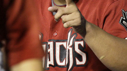 Diamondbacks pitcher Yusmeiro Petit sits in the dugout after pitching eight innings of one-hit baseball.