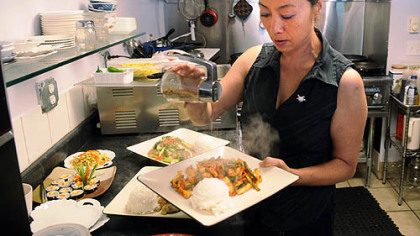 Yong Kwon prepares Oh Jing Un Bockeum (spicy squid) in the kitchen of her Cecil restaurant.