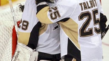 Penguins goalie Marc-Andre Fleury and Maxime Talbot celebrate after defeating the Flyers, 3-1, last night in Philadelphia to take a 3-1 lead in the series.