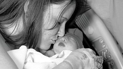 The first of many many kisses for Lane Leighty from his mom, Shawna, at St Clair Hospital after Lane's birth.