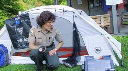 Rose Fuge, environmental educator with the state Department of Conservation and Natural Resources, demonstrates environmentally friendly camping techniques at Ohiopyle State Park.