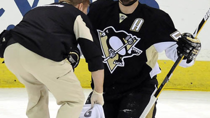 Sergei Gonchar is attended to after a knee injury that forced his exit in the first period of last night's playoff game against the Washington Capitals at Mellon Arena.
