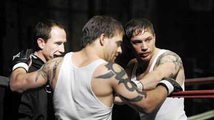 Eric Hibler, left, owner of Eric Hibler's Pittsburgh Fight Club, talks with stunt double Jace Jeanes, center, and actor Tom Hardy before a take on the set of "Warrior."