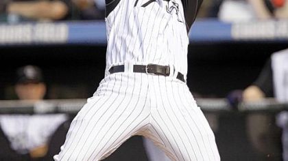 Colorado's Todd Helton reels from an inside pitch by Ross Ohlendorf in the fourth inning last night at Coors Field in Denver.