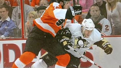 The Flyers' Mike Richards crunches Rob Scuderi against the boards in the first period of Game 4 of the NHL playoffs first-round series at Wachovia Center in Philadelphia.