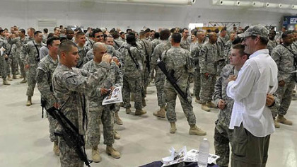 Former Pittsburgh Steeler head coach Bill Cowher poses for a photo  as dozens of U.S. troops gather during a USO appearance at Forward Operating Base Maraz in Mosul, Iraq, Thurday.