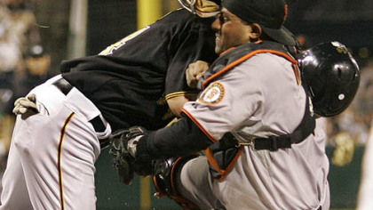 Giants catcher Bengie Molina holds onto the ball after colliding with Pirates outfielder Brandon Moss who was attempting to score in the seventh inning.