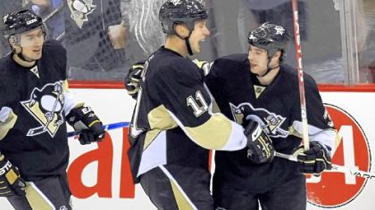 Jordan Staal, middle, skates in to congratulate Bill Thomas on his first NHL goal last night in the second period.