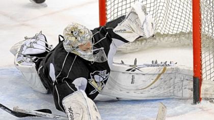 Penguins goalie Marc-Andre Fleury stops a shot by center Sidney Crosby during practice yesterday at Mellon Arena before leaving for Detroit to play Game 7 of the Stanley Cup final.