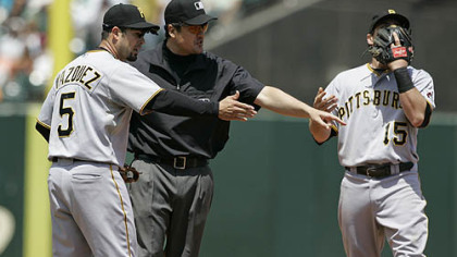 Pirates shortstop Ramon Vazquez argues with second base umpire Mike DiMuro as third baseman Andy LaRochecovers his face with his glove after Giants infielder Juan Uribe was called safe on a steal at second base in the fifth inning.