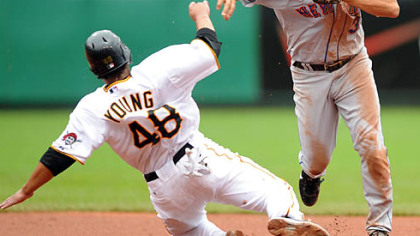 Mets shortstop Alex Cora throws to first base to finish a double play after forcing out Pirates outfielder Delwyn Young in the fourth inning yesterday.