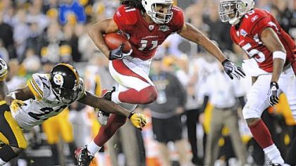 Cardinals receiver Larry Fitzgerald runs for a second-half first down last night in Super Bowl XLIII in Tampa, Fla.