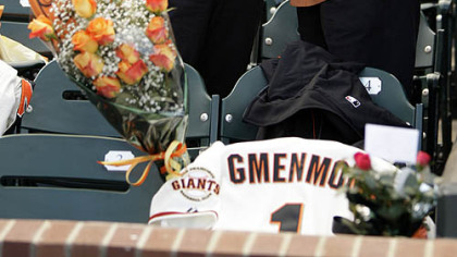 A couple weep near the seat of Sue Burns, a part owner of the Giants who lost her fight with cancer, prior to last night's game.
