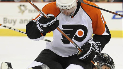 Evgeni Malkin is taken down by the Flyers' Jeff Carter in the first period.