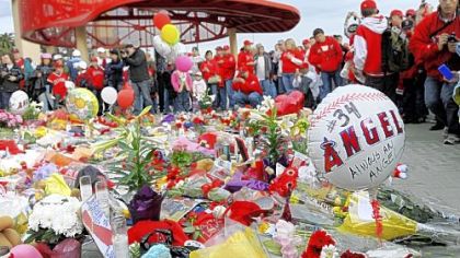 Angels fans gather around a temporary memorial for Los Angeles rookie pitcher Nick Adenhart before the game against the Red Sox last night in Anaheim, Calif.