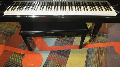 The hospital's sound-proofed music therapy room features a shiny baby grand piano, carpeting dotted with big musical notes and a dozen giant drums.