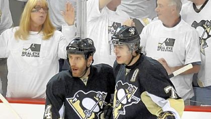 Rob Scuderi, left, is first to congratulate Evgeni Malkin after a goal in the series against the Carolina Hurricanes.