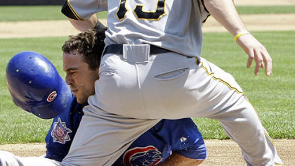 Cubs' Sam Fuld, left, is safe at third after hitting a triple off Pirates starting pitcher Charlie Morton as third baseman Andy LaRoche waits for the throw.