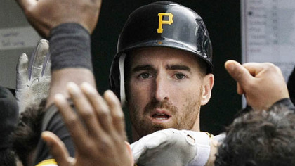 Adam LaRoche is greeted in the Pirates dugout after scoring off a hit by Ramon Vazquez during the fourth inning of yesterday's game against the Chicago Cubs.